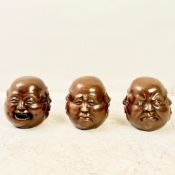 SET OF THREE FOUR SIDED BRONZE HEADS.