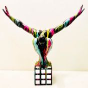 CONTEMPORARY DIVER SCULPTURE IN A PAINT SPLATTERED FINISH.
