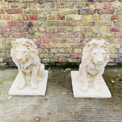 PAIR OF COMPOSITE STONE GARDEN LIONS.