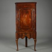 GEORGE III WALNUT CORNER CUPBOARD ON STAND.