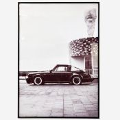 PHOTOGRAPHIC PRINT OF A PORSCHE IN A BLACK FRAME.