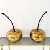 PAIR OF OVERSIZED CHERRY SCULPTURES IN A GILT FINISH.