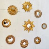 SET OF NINE SUNBURST DESIGN GILT FRAMED WALL MIRRORS.