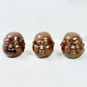 SET OF THREE FOUR SIDED BRONZE HEADS.