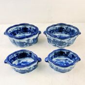 SET OF FOUR BLUE AND WHITE IRONSTONE STYLE CERAMIC PLANTERS.