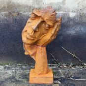 SURREALIST STYLE CAST METAL RESTING HEAD SCULPTURE.