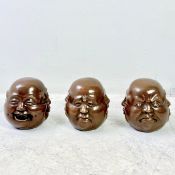 SET OF THREE MULTI SIDED BRONZE HEADS.