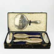 A GEORGE V SILVER BRUSH SET.