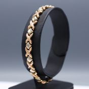 A YELLOW METAL TWO-TONE BRACELET.