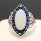 A PLATINUM OPAL AND SAPPHIRE NAVETTE RING.