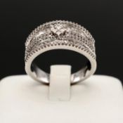 A 9CT WHITE GOLD DIAMOND HALF ETERNITY RING.