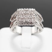 A 9CT WHITE GOLD DIAMOND CLUSTER RING.