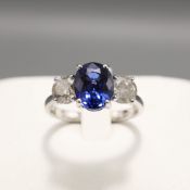 AN 18CT WHITE GOLD SAPPHIRE AND DIAMOND TRILOGY RING.