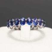 A PLATINUM SAPPHIRE ETERNITY RING.