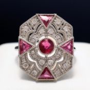 A PLATINUM OCTAGONAL PANEL RUBY AND DIAMOND RING.