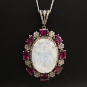 A SILVER OPAL, GARNET AND DIAMOND PENDANT.