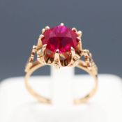 A YELLOW METAL RUBY SOLITAIRE RING.