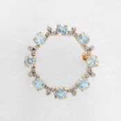 A 9CT GOLD BLUE TOPAZ AND DIAMOND SET BROOCH.