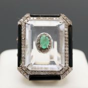 AN EMERALD, DIAMOND, CRYSTAL AND ONYX DRESS RING.