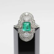 A PLATINUM EMERALD AND DIAMOND SET PANEL RING