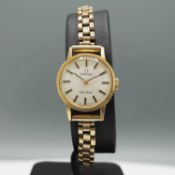 AN OMEGA 9CT GOLD LADIES WRISTWATCH.