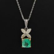 AN 18CT GOLD EMERALD AND DIAMOND PENDANT