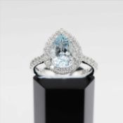 A PLATINUM AQUAMARINE AND DIAMOND CLUSTER RING
