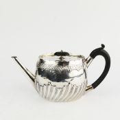 A VICTORIAN SILVER TEAPOT.