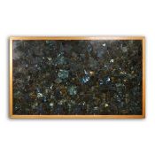 A LARGE FRAMED LABRADORITE PANEL.
