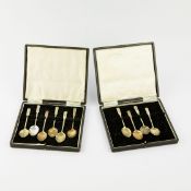 A SET OF TEN SILVER AND ENAMELLED COFFEE SPOONS.