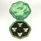 A BOXED WEST & SONS OF DUBLIN SET OF FOUR EMBOSSED SILVER SALTS.