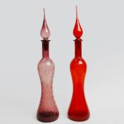 A PAIR OF AMETHYST AND RUBY GLASS DECANTERS.
