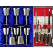A BOXED SET OF EIGHT CROWN AND ROSE PEWTER GOBLETS AND A BUTLERS ANTLER CARVING SET.