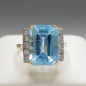 A 9CT GOLD TOPAZ AND DIAMOND SET RING.