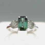 A PLATINUM TOURMALINE AND DIAMOND TRILOGY RING.