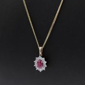 A 9CT GOLD RUBY AND DIAMOND CLUSTER PENDANT.