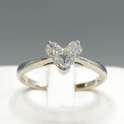 A WHITE METAL HEART SHAPED DIAMOND DRESS RING.