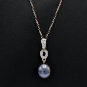 A 9CT ROSE GOLD ART DECO STYLE PENDANT.