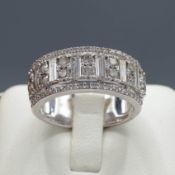 A 9CT WHITE GOLD DIAMOND HALF ETERNITY RING.