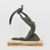 AN ART DECO SALVADO SPELTER FIGURE OF A GIRL AND PEACOCK.