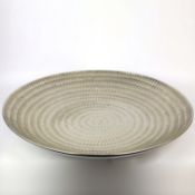 A LARGE FINK CERAMIC PLATE IN A METALIC NICKEL GLAZE.