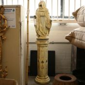 SCULPTURAL HOODED FIGURE ON STAND.