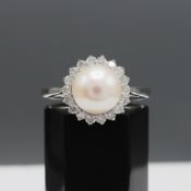 A 9CT WHITE GOLD PEARL AND DIAMOND RING