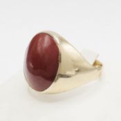 A 9CT GOLD RED CABOCHON RING