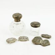 TWO BELT BUCKLES AND SILVER CAPPED GLASS DRESSING TABLE BOTTLES. (4)