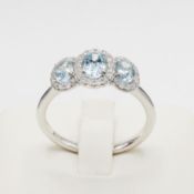 A PLATINUM AQUAMARINE AND DIAMOND TRILOGY RING