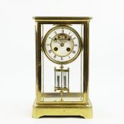 A FRENCH FOUR GLASS GILT METAL MANTEL CLOCK