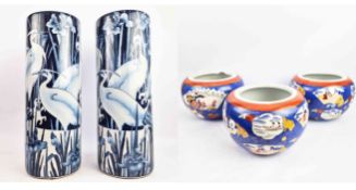 A PAIR OF CHINESE BLUE AND WHITE STICK STANDS AND THREE JAPANESE JARDINIERES. (5)