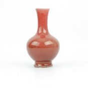 A CHINESE MONOCHROME SANG DE BOEUF BOTTLE VASE.