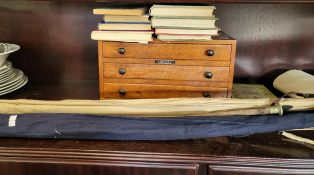Two fishing rods, a two-piece fly fishing Hardy, a vintage rod, nine fishing books, and a three-